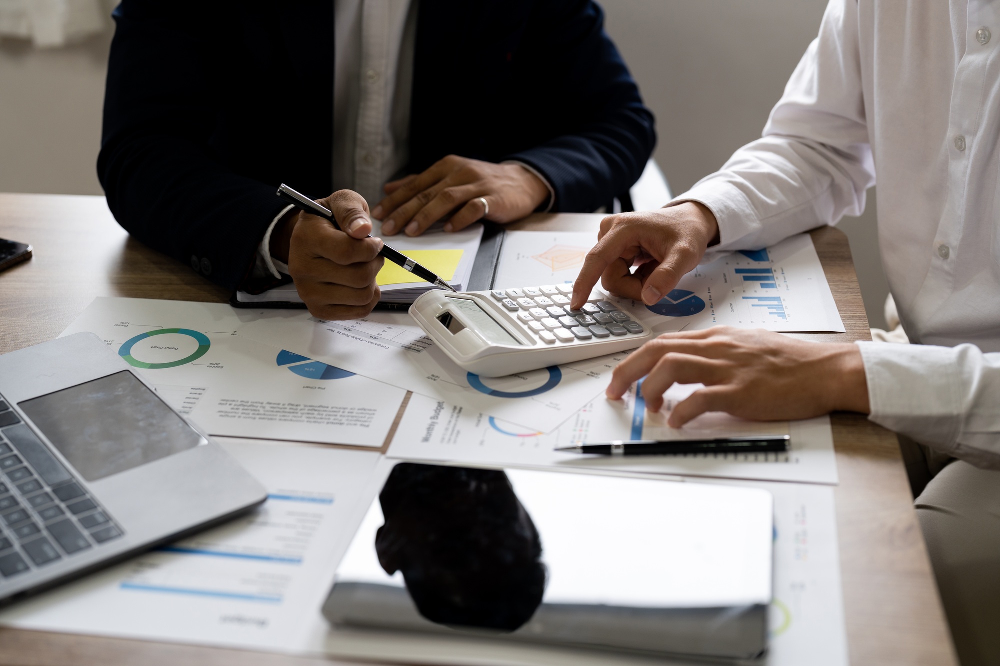 business owners consult adviser financial meeting to analyze and on the finance report. Financial