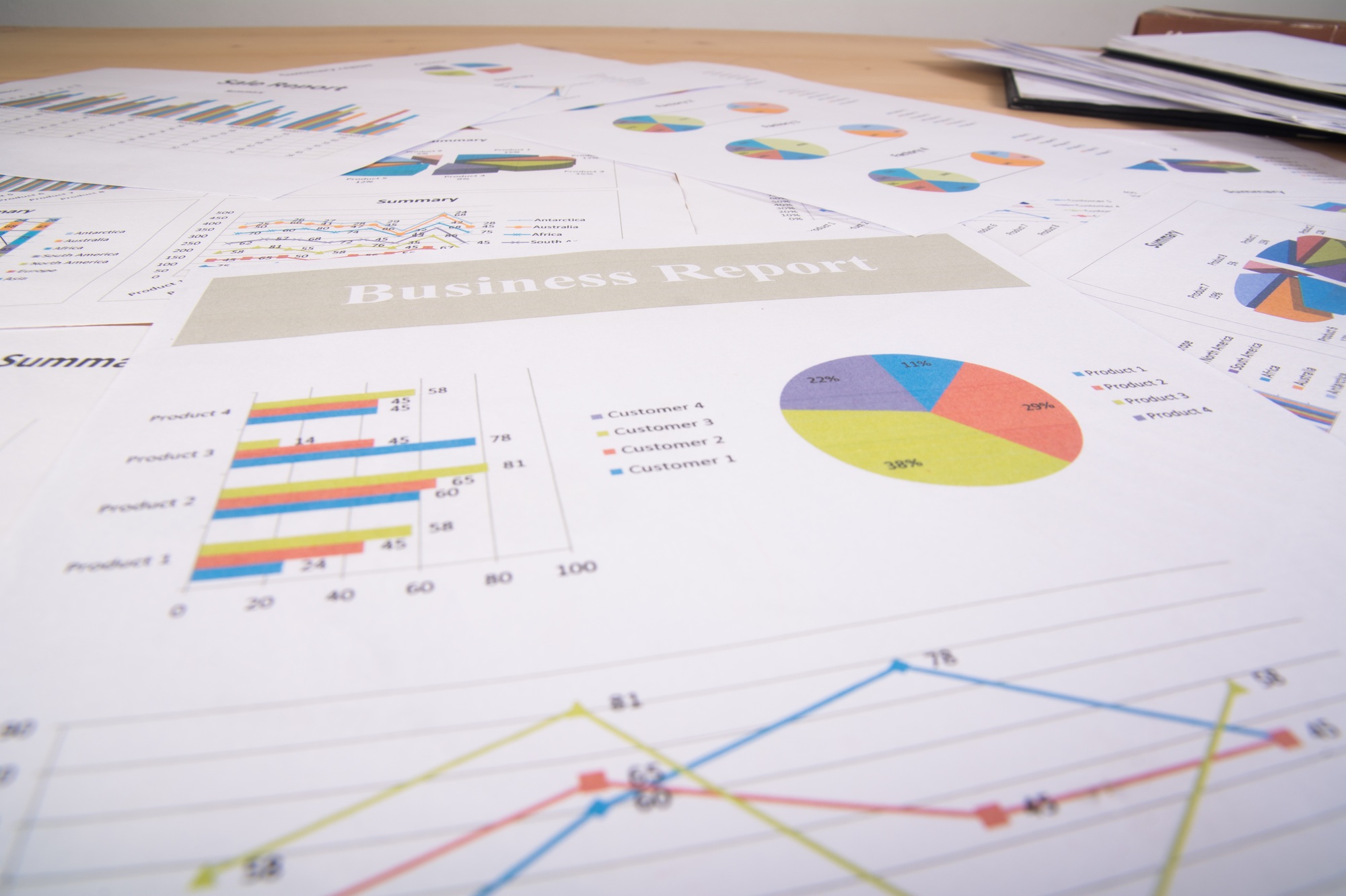 business report graphs and charts business reports and pile of documents business concept