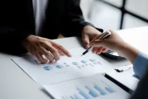 Company meeting room has businessmen and finance managers meeting together on finance topics.